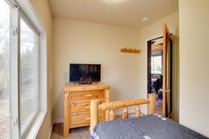 a bedroom with a bed and a tv on a dresser at Quaint Ironton Getaway with Fire Pit, Gas Grill! in Ironton