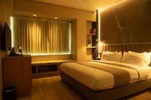 Postel nebo postele na pokoji v ubytování Vertigo Hotel