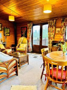 a living room with a couch and a table and chairs at Wigeon Secluded Rustic cabin in York +24 photos