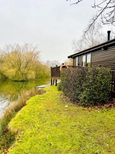 a building with a bench next to a body of water at Wigeon Secluded Rustic cabin in York