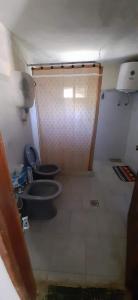 a small bathroom with a toilet and a sink at Casa San Luis Salerno in Ciudad de la Costa