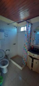 a bathroom with a toilet and a sink at Casa San Luis Salerno in Ciudad de la Costa