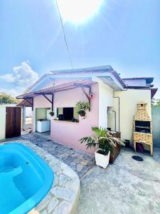 a small house with a swimming pool in front of it at Porto Mirim House in Ceará-Mirim