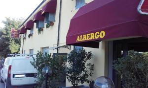 a purple awning with a albergo sign on a building at albergo in Parma