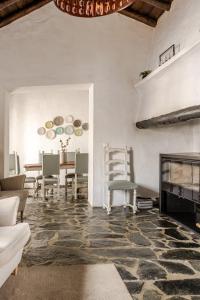 a living room with a fireplace and a table at Aleixo's House | Alentejo in Monforte