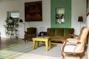 a living room with a couch and a table and chairs at Villa Lapax by Ericeira Property in Ericeira