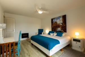 a bedroom with a bed and a desk and a tv at Villa Lapax by Ericeira Property in Ericeira +43 photos