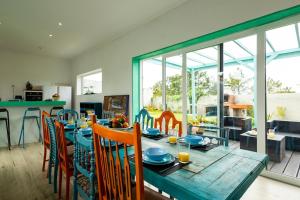 a dining room with a wooden table and chairs at Villa Lapax by Ericeira Property in Ericeira