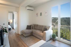 a living room with a couch and a large window at Casa Bella Vista in Diano Castello