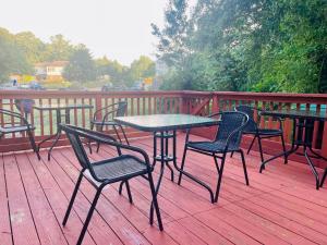 a table and chairs sitting on a deck at 1 bedroom terrace view with shared bathroom #3 in Laurel