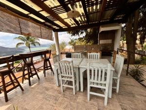 a table and chairs on a patio with a view at Cabañas Tr'eje in Valle de Bravo