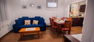 a living room with a blue couch and a table at Casa Rabel in Fuencaliente de la Palma