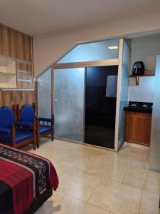 a room with a bed and a sliding glass door at Apartamento Studio in Diamantina