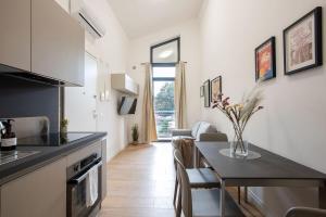 a kitchen with a table and a dining room at Urban Oasis near Termini, Free Parking&Balcony, int10 in Rome