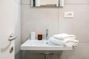 a bathroom with a white sink and a mirror at Urban Oasis near Termini, Free Parking&Balcony, int10 in Rome +71 photos