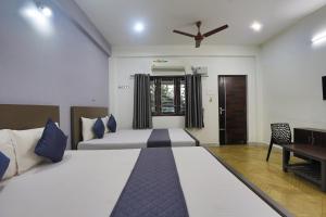 a bedroom with a large bed and a ceiling fan at SS Guest House in Chennai