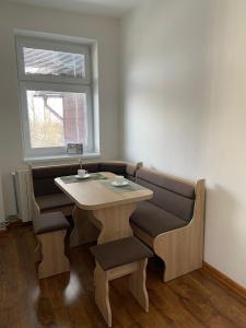 a table and chairs in a room with a window at Lomnica Lodge in Vysoké Tatry +11 photos