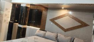 a room with a mirror and a couch with pillows at AK Beach House in Velankanni