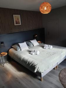 a bedroom with a large bed with two towels on it at Happiness Cottage in Colmar