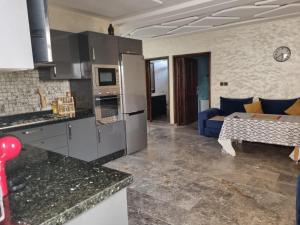 a kitchen and a living room with a couch at Riad Targante Takate 2 in Takkat