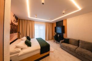 a hotel room with a bed and a couch at LAMBERT Residences in Lučenec