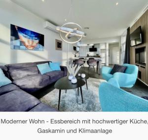 a living room with a couch and a table at Strand- Chalet Olburgen in Olburgen