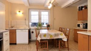 a kitchen with a table and some chairs and a table and a table andheastern at Pension Hoffmann in Trebra