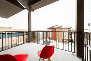 un balcone con sedie rosse e una vista di 2bedroom luxury Condo a Edmonton