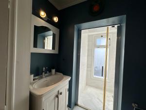 a bathroom with a white sink and a shower at Papalina in Ayvalık +19 photos