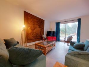 a living room with a couch and a coffee table at Gîte charmant avec jardin clos et parking à Saint-Sauveur-Marville - FR-1-581-146 in Saint-Sauveur-Marville