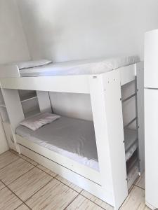 a white bunk bed in a room at Pousada Brisa do Mar in Tramandaí