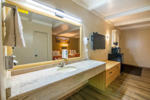 a bathroom with a sink and a large mirror at Glenwood Springs Cedar Lodge in Glenwood Springs +37 photos