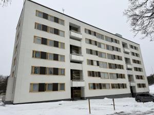 un grande edificio bianco con neve di fronte di La Casa De Kotka a Kotka
