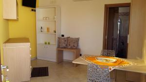 a kitchen with a table and a dining room at Monolocale SULE in San Foca