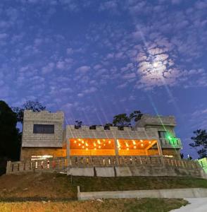 a building with lights on it at night at Pousada Castelo in São Carlos