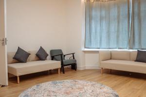a living room with two couches and a window at Spacious 13-Bed in the Heart of Headingley in Headingley +60 photos