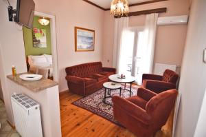 a living room with leather chairs and a table at Konstantina's Sky View in Kastoria +13 photos