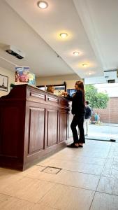 a woman standing at a counter in a store at Hotel Miami in San Miguel de Tucumán +27 photos