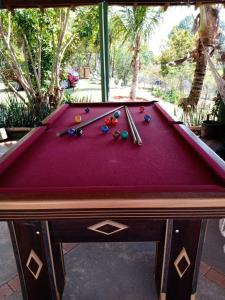 a pool table with balls and cuesticks on it at Chácara Buíque&Xique in Jarinu
