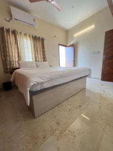 a bedroom with a large bed in a room at Western Royal Homes in Bengaluru
