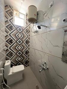a bathroom with a toilet and a sink at Western Royal Homes in Bengaluru +5 photos