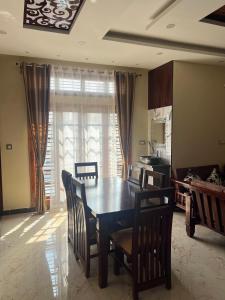 a dining room table and chairs in a room at Western Royal Homes in Bengaluru