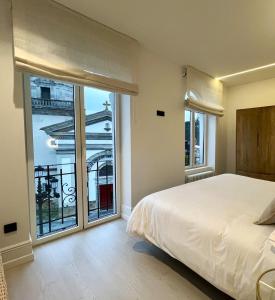 a bedroom with a bed and a large window at Las Terrazas de Candás in Candás