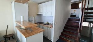 a small kitchen with a staircase leading up to a room at Résidence Plein Ciel - maeva Home - Appartement 2 pièces 5 personnes - Confort MAE-1211 in La Mongie