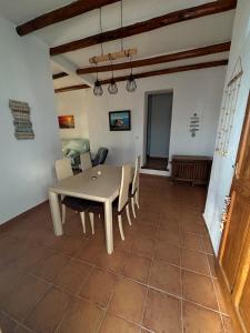 a dining room with a table and chairs at Casa Playa Lance in Adra +5 photos