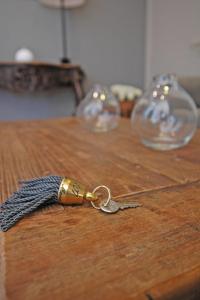 a pair of keys sitting on a wooden table at Hotel Santa Maria in Saint-Florent