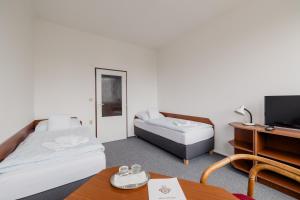 Postel nebo postele na pokoji v ubytování hotel Dobruška