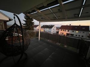 a balcony with a hammock on a roof with buildings at Apartment with flair and top location in Rutesheim