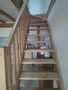 a staircase with wooden risers in a house at Chalet spacieux avec jardin à La Longeville in La Longeville +4 photos