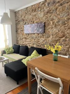 a living room with a couch and a table at La Casa de la Plaza in Cee
